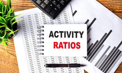 ACTIVITY RATIOS text on notebook on chart with calculator and pen