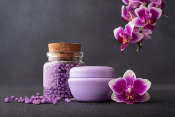 Obraz na płótnie Canvas Bath products for wellness and spa with purple orchid flowers