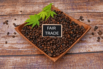 Coffee beans in a wooden bowl with the inscription Fair Trade.