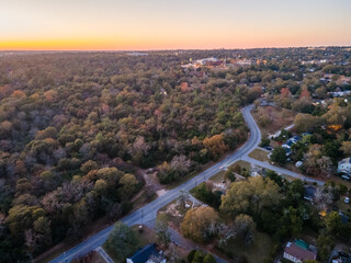 Aerial landscape of forest and suburban neighborhood at sunset in Augusta Georgia - obrazy, fototapety, plakaty