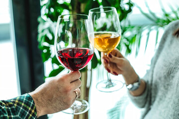 Man and Woman Holding Wine Glasses at a Party