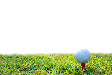 The golf ball sits on a red tee and stands out against the green grass. Isolated white background.