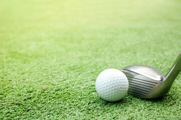 Golf balls and tees are placed on artificial grass.