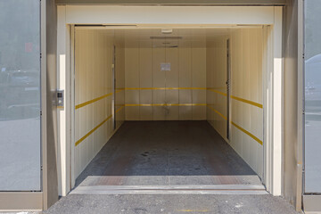 Open Door at Elevator Lift for Cars Access to Underground Parking Garage