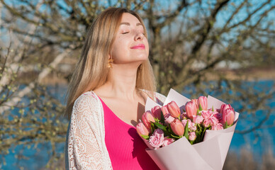 Natural women's beauty without plastic surgery and no photoshop. European lady mixed race. Lady of middle age as she is with bouquet of flowers