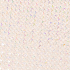Texture made from iridescent transparent acrylic beads on a beige background.