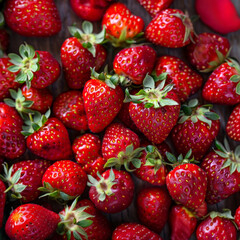 Fototapeta premium Background with freshly picked ripe strawberries. Locally grown summer delicious, tasty and healthy berries