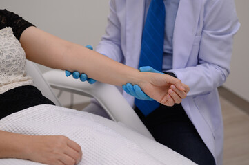 The doctor will examine the skin on the patient's arm with a laser.