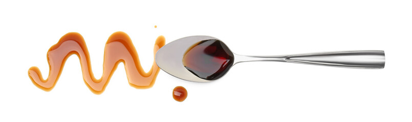 Tasty soy sauce and spoon isolated on white, top view