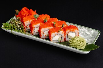 Sushi Roll with Caviar, Cream Cheese, Cucumber, and Wasabi on Ceramic Plate
