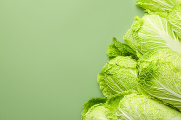 Many fresh Chinese cabbages on pale green background, top view. Space for text