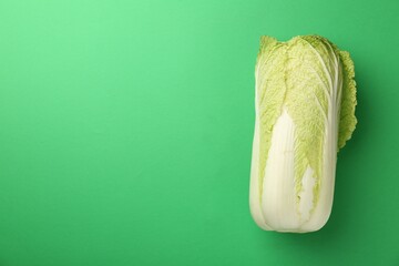 Fresh ripe Chinese cabbage on green background, top view. Space for text - obrazy, fototapety, plakaty