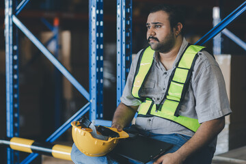 Warehouse worker working in warehouse storage. Foreman or worker work at factory site check up...