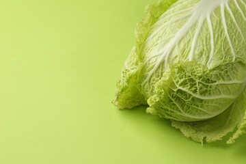Fresh ripe Chinese cabbage on light green background. Space for text - obrazy, fototapety, plakaty