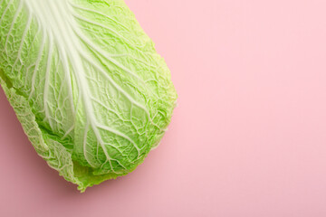 Fresh ripe Chinese cabbage on pink background, top view. Space for text