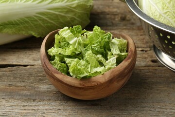 Cut fresh Chinese cabbage on wooden table, closeup