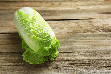 Fresh ripe Chinese cabbage on wooden table, space for text - obrazy, fototapety, plakaty