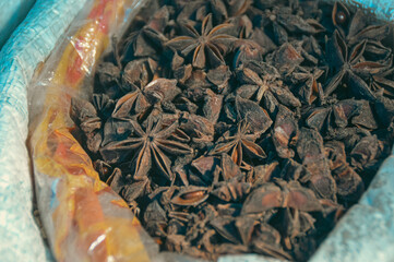 Close-up of aromatic star anise or Illicium verumin a plastic bag at a local market stall