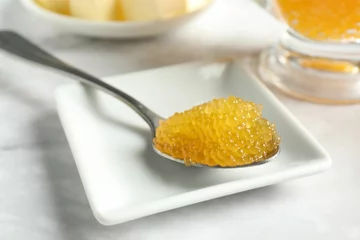 Gordijnen Fresh pike caviar in spoon on white marble table, closeup © New Africa