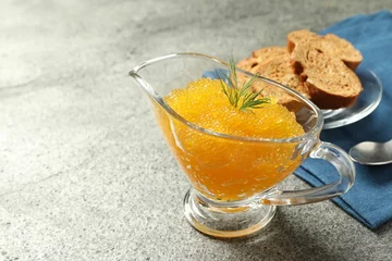 Foto op Plexiglas Fresh pike caviar in gravy boat, bread and spoon on grey table, closeup. Space for text © New Africa