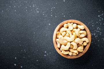 Cashew nuts in bowl at black background. Flat lay with space for text. - 783200731