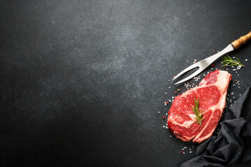 Raw meat steak with spices on black background. Beef steak ribeye. Top view with copy space. - 783205171