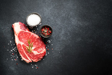 Beef steak. Ribeye dry aged steak raw meat on black. Top view with copy space. - 783205501
