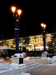 retro style lanterns on a winter night in the city center - 783207329