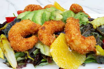 Mediterranean salad. Closeup view of colorful salad with lettuce, cabbage, tomatoes, fried shrimps,...