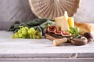 cheese board with baguette and grapes