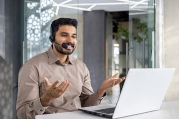 A cheerful customer service representative talks using headset in a modern office setting, assisting clients with expertise and a smile