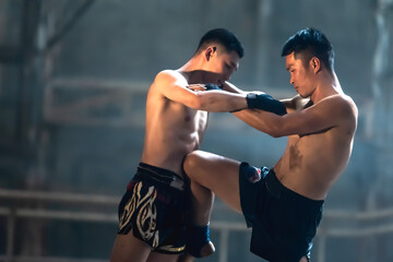 Fototapeta na wymiar Muay Thai boxer men doing Thai boxing competition 
