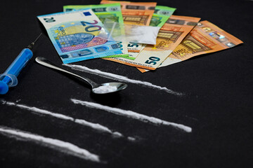 cocaine lines with syringe and spoon, bag full of heroin on black background and pile of euro money. stop drugs and addiction