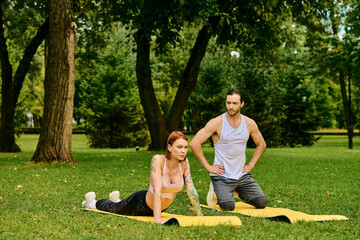 A woman in sportswear practice yoga poses in a lush park guided by a personal trainer, embodying...