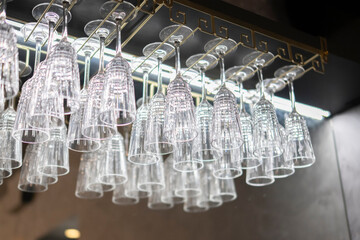 Array of Sparkling Bar Glasses Neatly Arranged on a Hanging Glass Rack