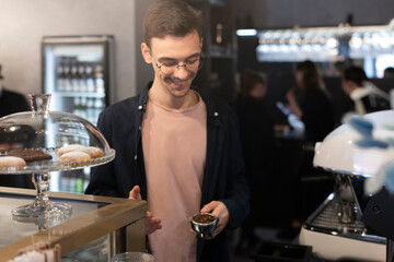 Barista Presents a Portafilter Full of Fresh Coffee Beans