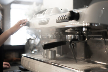 Preparing a Fresh Cup of Espresso With a Professional Coffee Machine in the Morning with steam