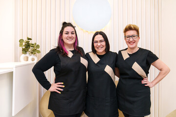 Three professionals stand ready in a hair clinic.