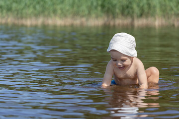 baby playing in the water on a hot summer day, baby safety and supervision, baby sunscreen