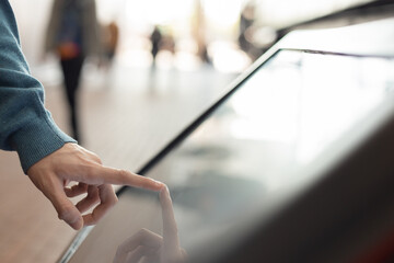 electronic self-service terminal, check in for a flight or buy tickets for public transport