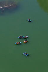Six inflatable boats on a rafting tour on the Colorado in the deep gorge of Marble Canyon below the...