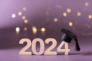 Number 2024 with graduated cap and bokeh lights. Class of 2024 concept