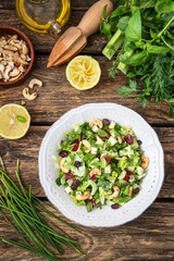 Fresh salad with herbs, apples and cranberries