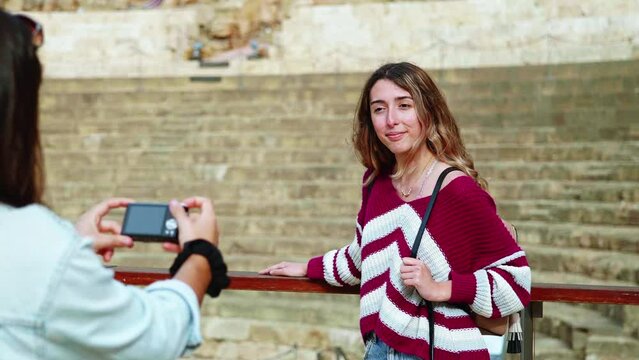 Two girls take a picture and make memories in a tourist city, Malaga, Spain.