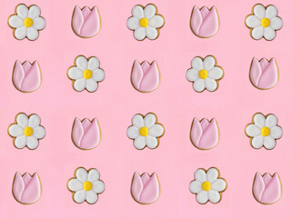 Gingerbread cookies in the shape of chamomile and tulip on the pink background. Pattern. Flat lay.