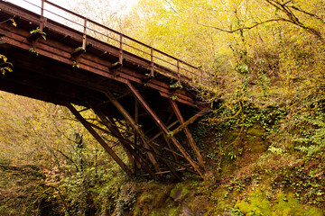 Old iron rusty bridge over a mountain river