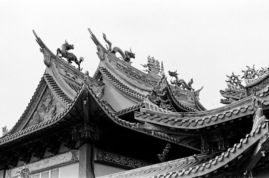 Ornate Dragons Adorning Ancient Temple Rooftop