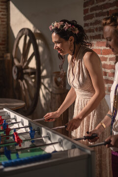 Bride playing table football