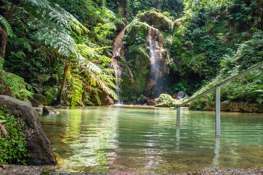 Water in thermal spring pool with waterfall falling from the rock in the natural monument of Caldeira Velha, São Miguel - Azores PORTUGAL