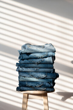 Neatly folded denim jeans on chair